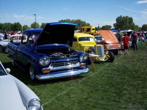 1972 Ford Ranchero - A blue 1959 Chevrolet pickup truck is displayed with its hood open at an outdoor car show.