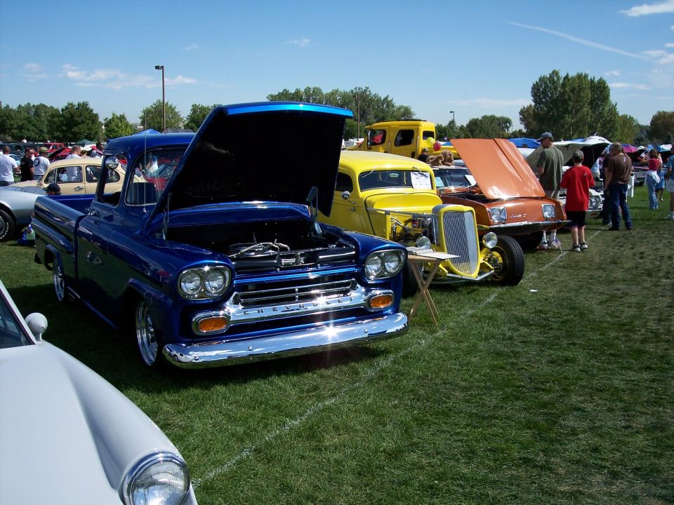 Blue 1959 Chevrolet pickup truck front view, hood open, showing chrome grille and headlights