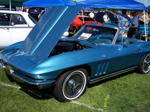 1972 Ford Ranchero - A blue convertible sports car is displayed with its hood open at an outdoor car show.