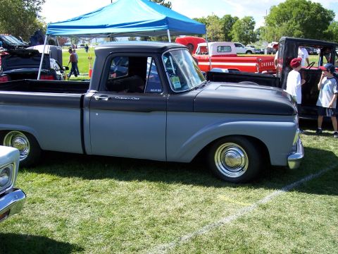 1972 Ford Ranchero - This 1956 Ford F-100 pickup truck is displayed at an outdoor event with other vehicles present.