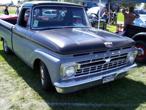 1972 Ford Ranchero - A classic Ford pickup truck is displayed on a grassy field, possibly at a car show.
