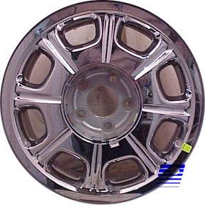1999 Lincoln Town Car - This is a close-up of a chrome wheel cover, likely for a luxury sedan, a distinctive spoke design.