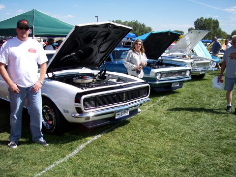 1972 Ford Ranchero - A white 1969 Chevrolet Camaro is displayed with its hood open at an outdoor car show.