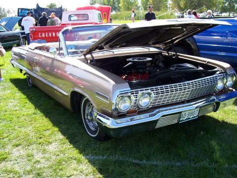 1972 Ford Ranchero - This 1963 Chevrolet Impala convertible was displayed with its hood up at an outdoor car show.
