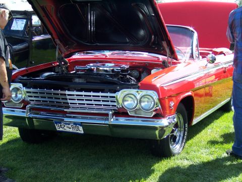 1972 Ford Ranchero - A classic red convertible is displayed with its hood up, revealing the engine bay and chrome details.