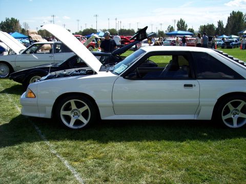 1972 Ford Ranchero - A white third-generation Ford Mustang is displayed with its hood open at an outdoor car show.