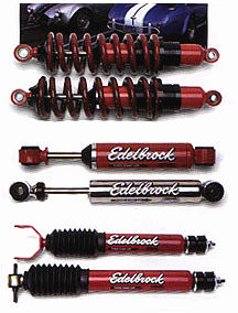 1999 Lincoln Town Car - A collection of four red Edelbrock shock absorbers and one black shock absorber, with visible branding and website text.