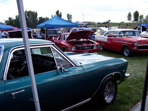 1972 Ford Ranchero - Foreground teal 1966 Ford Ranchero shows its interior and side, with other classic cars in the background.