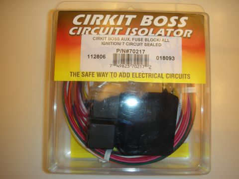 1998 Ford Crown Victoria - Cirkit Boss aux fuse-block circuit isolator wiring kit sealed in its retail blister package on a tan surface.