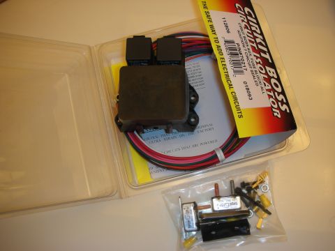 1998 Ford Crown Victoria - opened Cirkit Boss isolator kit laid out showing relays, color-coded wiring and a bag of mounting hardware.