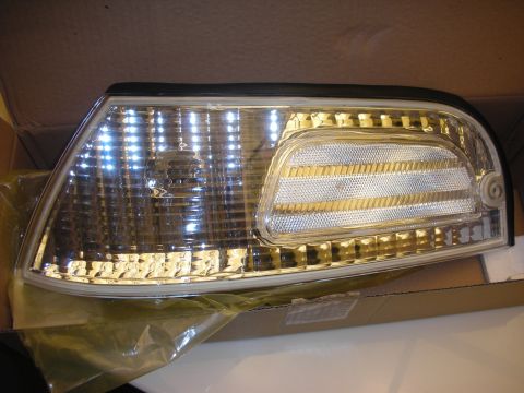 1998 Ford Crown Victoria - clear automotive front corner lens assembly for a turn signal sits in a cardboard box with packaging.