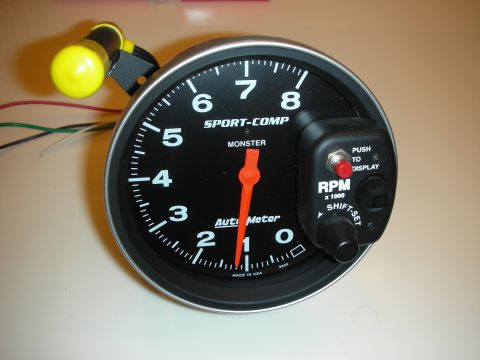 1998 Ford Crown Victoria - Auto Meter Sport-Comp Monster pedestal tachometer with a black face reading 0-8 RPM x1000 and a shift light beside it.
