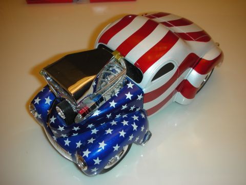 1998 Ford Crown Victoria - diecast coupe hot rod painted in the American flag with stars-and-stripes bodywork and a chrome engine, rear-quarter view.