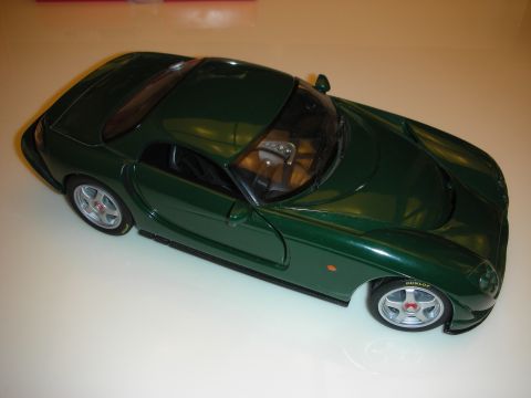1998 Ford Crown Victoria - British racing green diecast sports coupe model with silver wheels, shown from a high front three-quarter angle.