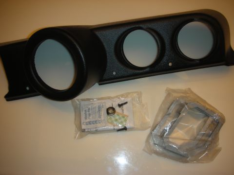 1998 Ford Crown Victoria - black triple-gauge dashboard pod bezel laid out with a bag of mounting hardware and clamp brackets.
