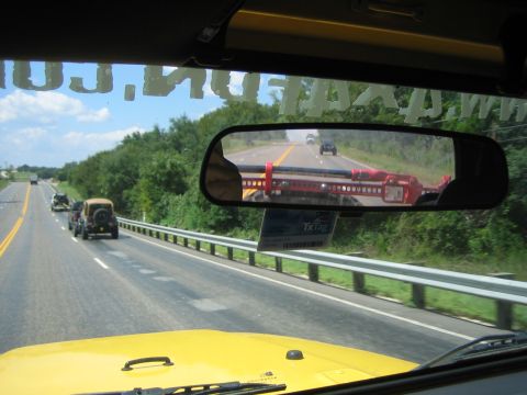 2001 Jeep Wrangler - Driving on a highway with other vehicles, including a Jeep Wrangler, on a sunny day.