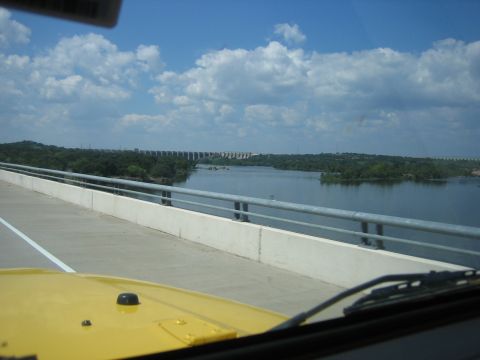2001 Jeep Wrangler - View from a bridge of a large dam across a wide river under a partly cloudy sky.