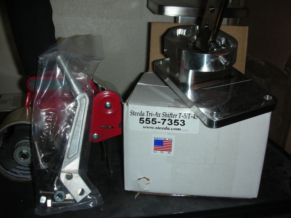 Steeda Tri-Ax shifter for T-5/T-45, polished assembly beside box labeled 555-7353