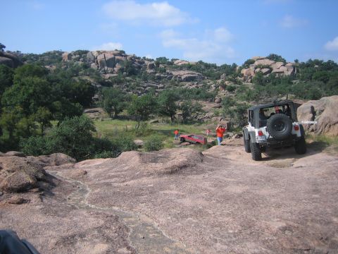 2001 Jeep Wrangler - A white 2001 Jeep Wrangler navigates a rocky trail, with another Jeep visible in the distance.