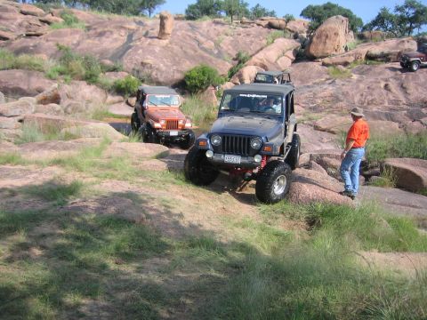 2001 Jeep Wrangler - Several Jeeps navigate a challenging rocky landscape during an off-road excursion.