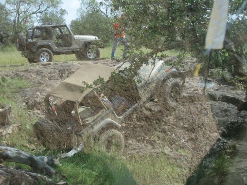 2001 Jeep Wrangler - Jeeps tackle a challenging off-road course with steep inclines and mud.