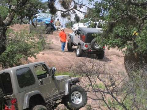 2001 Jeep Wrangler - Multiple Jeep Wranglers navigate a challenging rocky trail during an off-road event.