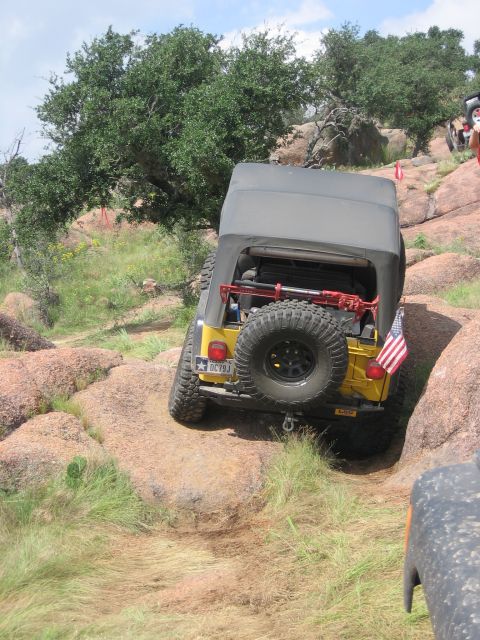 2001 Jeep Wrangler - Jeep Wrangler tackling a challenging rocky trail during an off-road event.