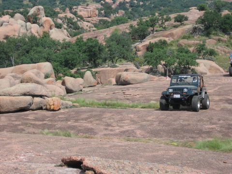 2001 Jeep Wrangler - A Jeep navigates a rocky landscape, its off-road capabilities.