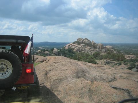 2001 Jeep Wrangler - Jeep Wrangler parked on rocky terrain, with a Texas flag visible.