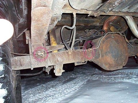 1989 Ford F-150 - Close-up of vehicle's rear axle and suspension components, with brake lines highlighted.