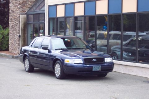 2001 Ford Crown Victoria - 2001 Ford Crown Victoria parked outside a commercial building.