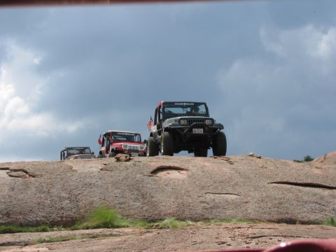 2001 Jeep Wrangler - Jeep convoy navigating a challenging rocky landscape on a cloudy day.