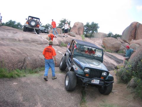 2001 Jeep Wrangler - Off-roaders navigate a rocky trail with assistance from a trail guide.