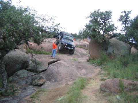2001 Jeep Wrangler - A 2001 Jeep Wrangler navigates a challenging rocky trail with another Jeep visible in the background.