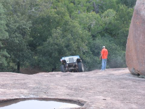 2001 Jeep Wrangler - A blue 2001 Jeep Wrangler navigates a challenging rocky landscape during an off-road excursion.