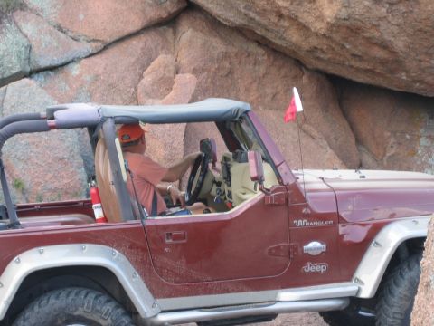 2001 Jeep Wrangler - Driver navigates a Jeep Wrangler through a rocky terrain during an off-road event.
