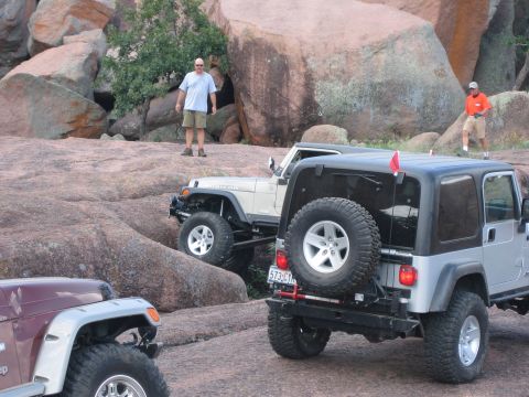 2001 Jeep Wrangler - Several Jeep Wranglers navigate a challenging rocky landscape during an off-road event.