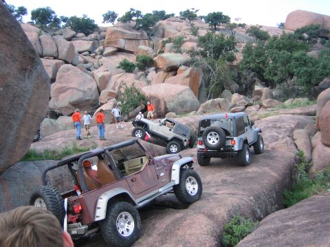 2001 Jeep Wrangler - Multiple Jeep Wranglers navigate a challenging rocky course during an off-road event.