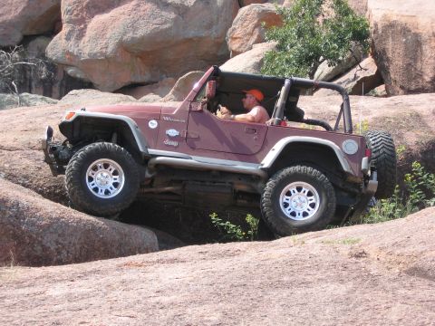 2001 Jeep Wrangler - A Jeep Wrangler navigates a rocky terrain, its off-road capabilities.