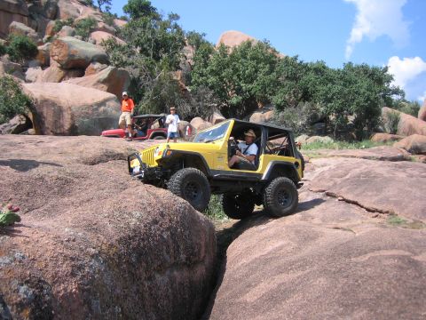 2001 Jeep Wrangler - Two Jeeps tackle a challenging rocky terrain during an off-road excursion.