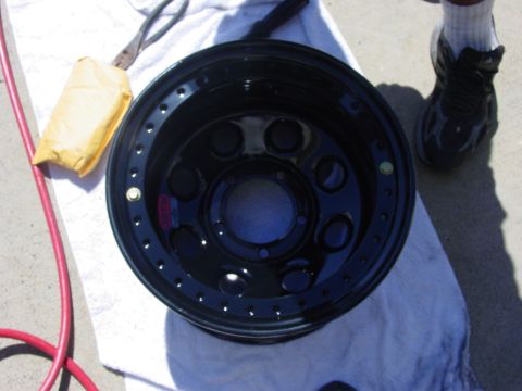 1994 Ford Bronco - A black aftermarket wheel is shown on a towel with tools nearby.