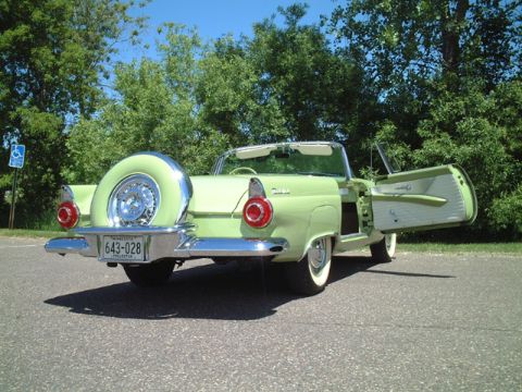 1956 Ford Thunderbird - A 1956 Ford Thunderbird convertible is shown from the rear, its iconic continental kit and distinctive tail lights.
