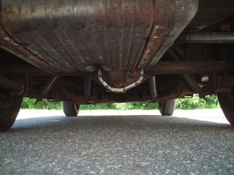 1956 Ford Thunderbird - Underside view of a car's drivetrain components, including the differential and exhaust.