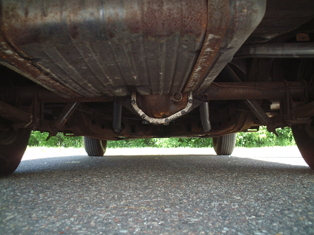 Underside view of a car showing the differential, exhaust system, and fuel tank