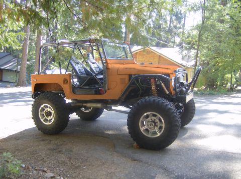 1989 Ford Bronco - This heavily modified off-road vehicle features a custom roll cage and oversized tires, suggesting it's built for terrain.