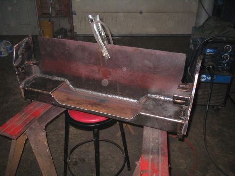 1979 Ford Bronco - A custom bumper part is shown undergoing fabrication, supported by sawhorses in a workshop setting.