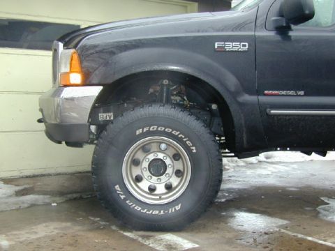 2000 Ford F-350 - Front view of a black 2000 Ford F-350 Super Duty showing the fender, headlight, and tire.
