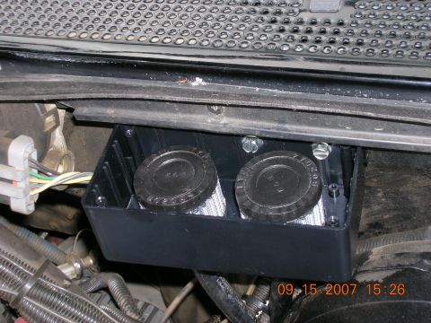 1996 Ford Bronco - A black plastic housing containing two circular filters is visible in the engine bay.