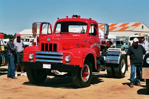 1981 Kenworth W900A - A red International truck is parked at an outdoor event with several people around it.