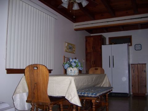 1991 Ford Bronco - A dining area with a table, chairs, and a refrigerator is visible in the room.